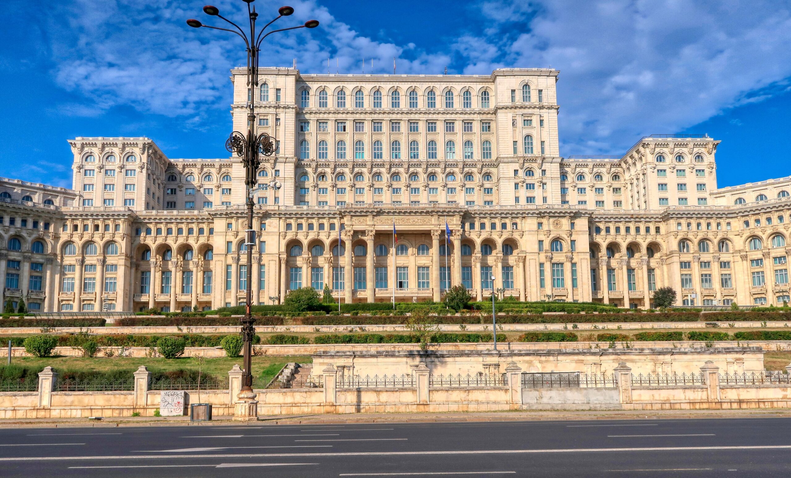 Panoramic view of the Palace of Parliament in Bucharest during a city tour, showcasing its massive and intricate architecture.